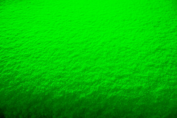 Colored snow as a background. Green background.