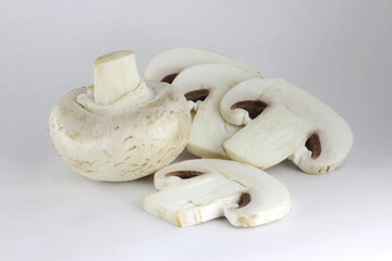 sliced champignons on a white background
