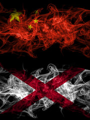 China, Chinese vs Alabama, Alabamian smoky mystic flags placed side by side. Thick colored silky abstract smoke flags.