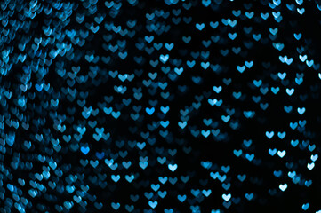 Color Bokeh on a dark background with hearts for use in graphic design