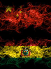China, Chinese vs Bolivia, Bolivian smoky mystic flags placed side by side. Thick colored silky abstract smoke flags.