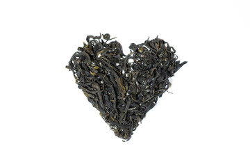 Green tea leaves in heart shape. Organic Georgian dry green tea. for making hot tea. Tea lover. Healthy beverage.