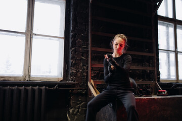 Girl fighter bandages her hands before training in the gym. Red Neon Light