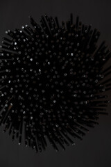 sheaf of black spaghetti on black background