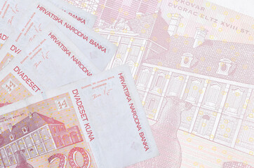 20 Croatian kuna bills lies in stack on background of big semi-transparent banknote. Abstract...
