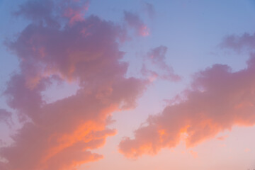 Pastel blue sky with pastel pink and orange clouds. Concept: background and nature.
