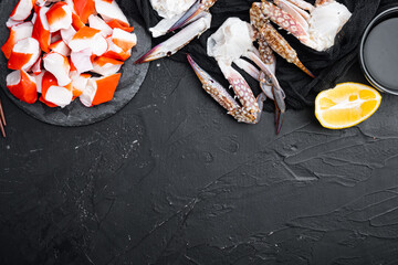 Crab sticks seafood semi finished fish mince with blue swimming crab, on stone board, on black background, top view flat lay  , with copyspace  and space for text