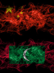 China, Chinese vs Maldives, Maldivian smoky mystic flags placed side by side. Thick colored silky abstract smoke flags.