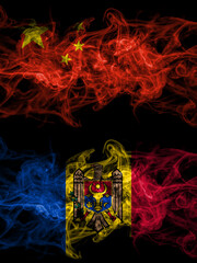 China, Chinese vs Moldova, Moldovan smoky mystic flags placed side by side. Thick colored silky abstract smoke flags.