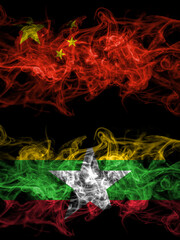 China, Chinese vs Myanmar, Burmese smoky mystic flags placed side by side. Thick colored silky abstract smoke flags.
