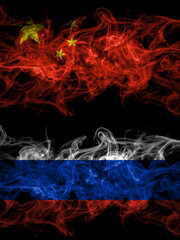 China, Chinese vs Russia, Russian smoky mystic flags placed side by side. Thick colored silky abstract smoke flags.