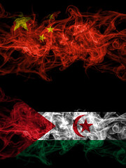China, Chinese vs Sahrawi smoky mystic flags placed side by side. Thick colored silky abstract smoke flags.