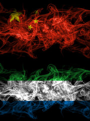 China, Chinese vs Sierra Leone smoky mystic flags placed side by side. Thick colored silky abstract smoke flags.