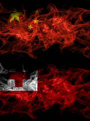 China, Chinese vs Tonga smoky mystic flags placed side by side. Thick colored silky abstract smoke flags.
