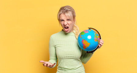 blonde woman looking angry, annoyed and frustrated screaming wtf or what’s wrong with you