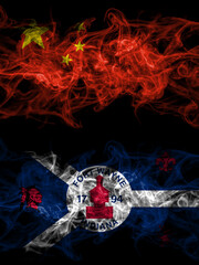 China, Chinese vs United States of America, America, US, USA, American, Fort Wayne, Indiana smoky mystic flags placed side by side. Thick colored silky abstract smoke flags.