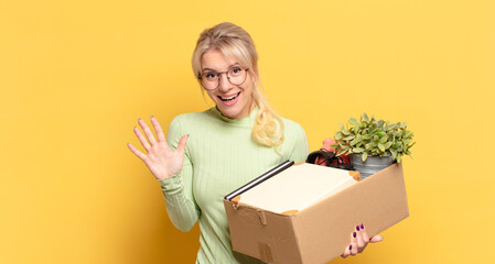blonde woman smiling and looking friendly, showing number five or fifth with hand forward, counting down