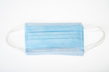 Blue medical disposable masks on white background, protection against coronavirus