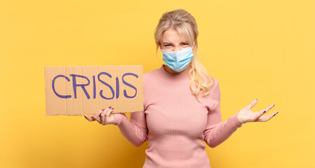 blonde woman looking angry, annoyed and frustrated screaming wtf or what’s wrong with you