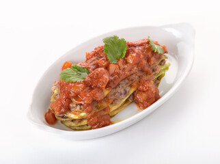 zucchini and stewed vegetables on a white plate 