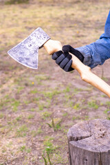 An axe  in the hands of a man