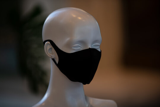The head of a mannequin in a protective mask during a pandemic. Fashion and business in quarantine.