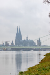 Fototapeta premium panorama of Cologne with cathedral great St. Martin and hohenzollern bridge at snowy weather. rhine river with high water