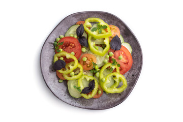 Vegetarian salad from green pea, tomatoes, pepper and basil isolated on white background. Top view.