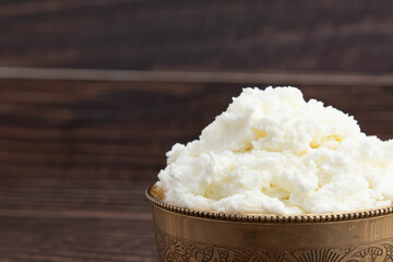 Natural Ayurvedic Freshly Churned White Butter Also Known As Safed Makhan Malai Or Makkhan Is Used For Skincare As Beauty Product And Has Multiple Health Benefits. Wooden Background With Copy Space