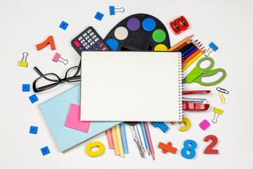 Stationery accessories and school notebook on a white background. Education and freelancer work concept. Back to school or office Flat lay, top view with copy space.