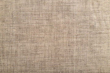 Fototapeta na wymiar Fragment of smooth brown linen tissue. Top view, natural textile background.