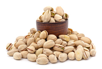 Pistachios in a bowl and around.