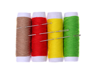 Four spools of thread and needles.