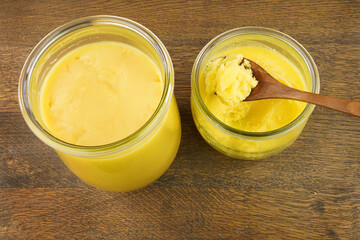 Homemade ghee (Sade yag) in jars and wooden spoon . Ghee is purified butter.   