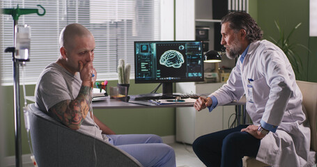 Doctor delivering bad news to patient during chemotherapy