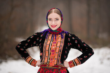 Slovak folklore. Traditional folk costume. Beautiful folk dancer in winter.