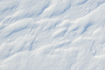 Fresh clean white snow background texture. Winter background with frozen snowflakes and snow mounds. Snow lumps. Seasonal landscape details. Cold weather.