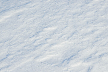 Fresh clean white snow background texture. Winter background with frozen snowflakes and snow mounds. Snow lumps. Seasonal landscape details. Cold weather.