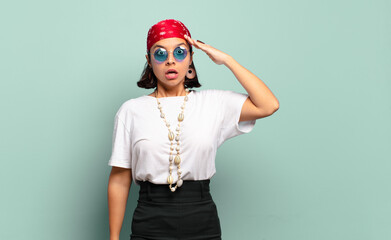 young latin woman looking happy, astonished and surprised, smiling and realizing amazing and...