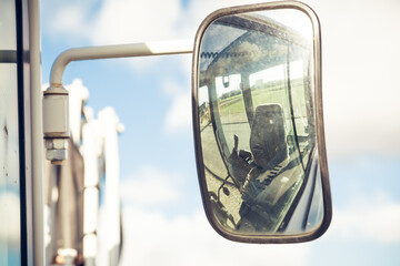Mirror of excavator showing the inner of the cabin