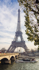 Fototapeta na wymiar Cruise touristic boat over Seine River with majestic Eiffel tower at background, Paris, France.