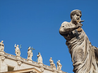 Fototapeta na wymiar Sculpture on Famous St. Peters square or Piazza San Pietro in Rome with Saint Peter basilica