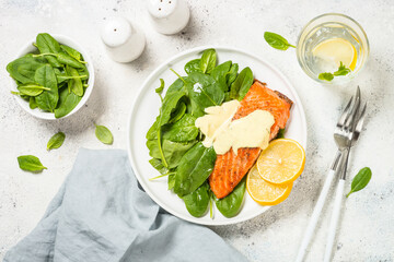 Salmon fillet with fresh salad and yogurt dressing. Healthy food, keto diet. Healthy lunch or dinner. Top view at white.