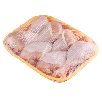 Raw and uncooked chicken drumsticks in a yellow plastic container. Meat of poultry in tray, isolated on white background.