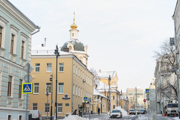 Moscow, Russia, Jan 15, 2021: Zvonarsky side street. Winter. Piles of snow. St' Nicolas church.
