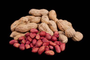 Heap of peanuts isolated on a black background.