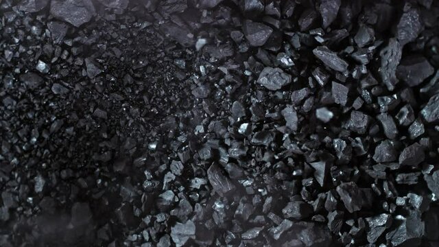 Super Slow Motion Shot of Crushing Coal on Black Background at 1000 fps.