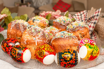 Traditional Russian Orthodox Easter cakes - Kulich (aka: Paska Easter Bread), with colored printed eggs surrounded by flowers.