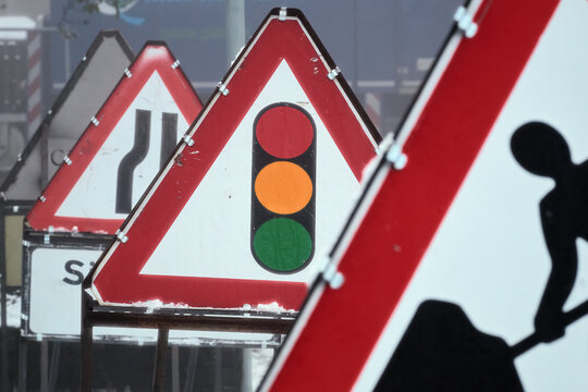 Road signs on the winter road. Signs Traffic light and Roadworks. Scotland, United Kingdom
