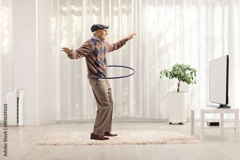 Poster cheerful man having fun and spinning a hula hoop